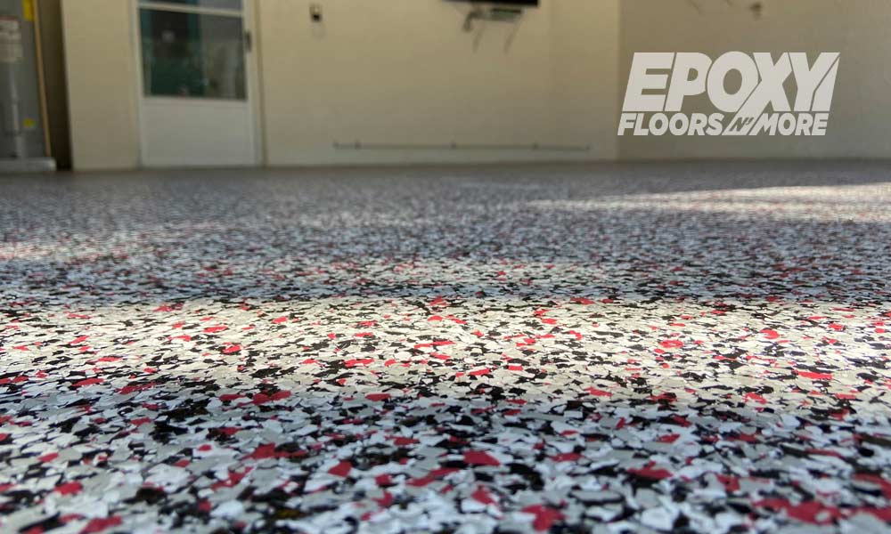 Epoxy flooring tools and materials arranged on a prepped concrete slab in Southwest Florida