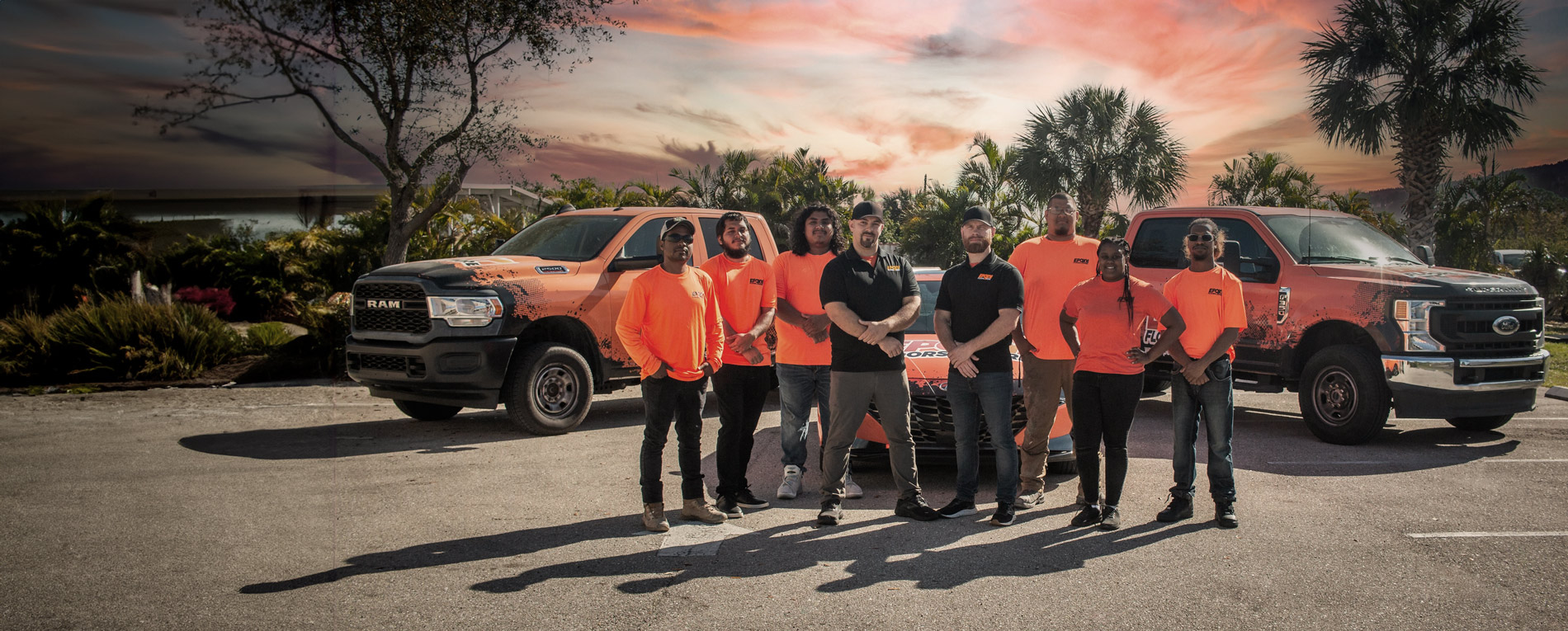 Epoxy Floors N More team in front of company vehicles